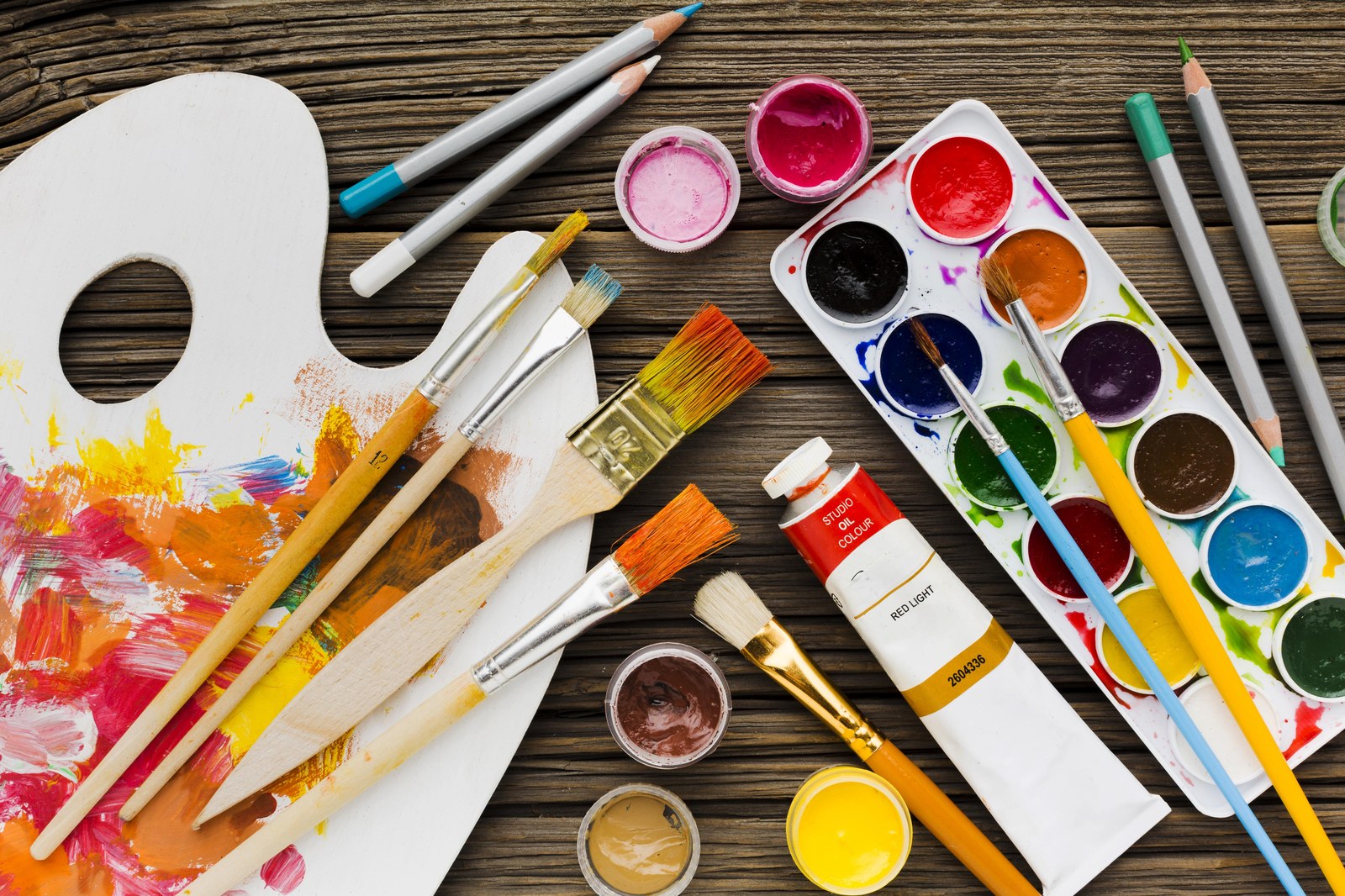 Art supplies — brushes, palette and paints at Del' Arts studio